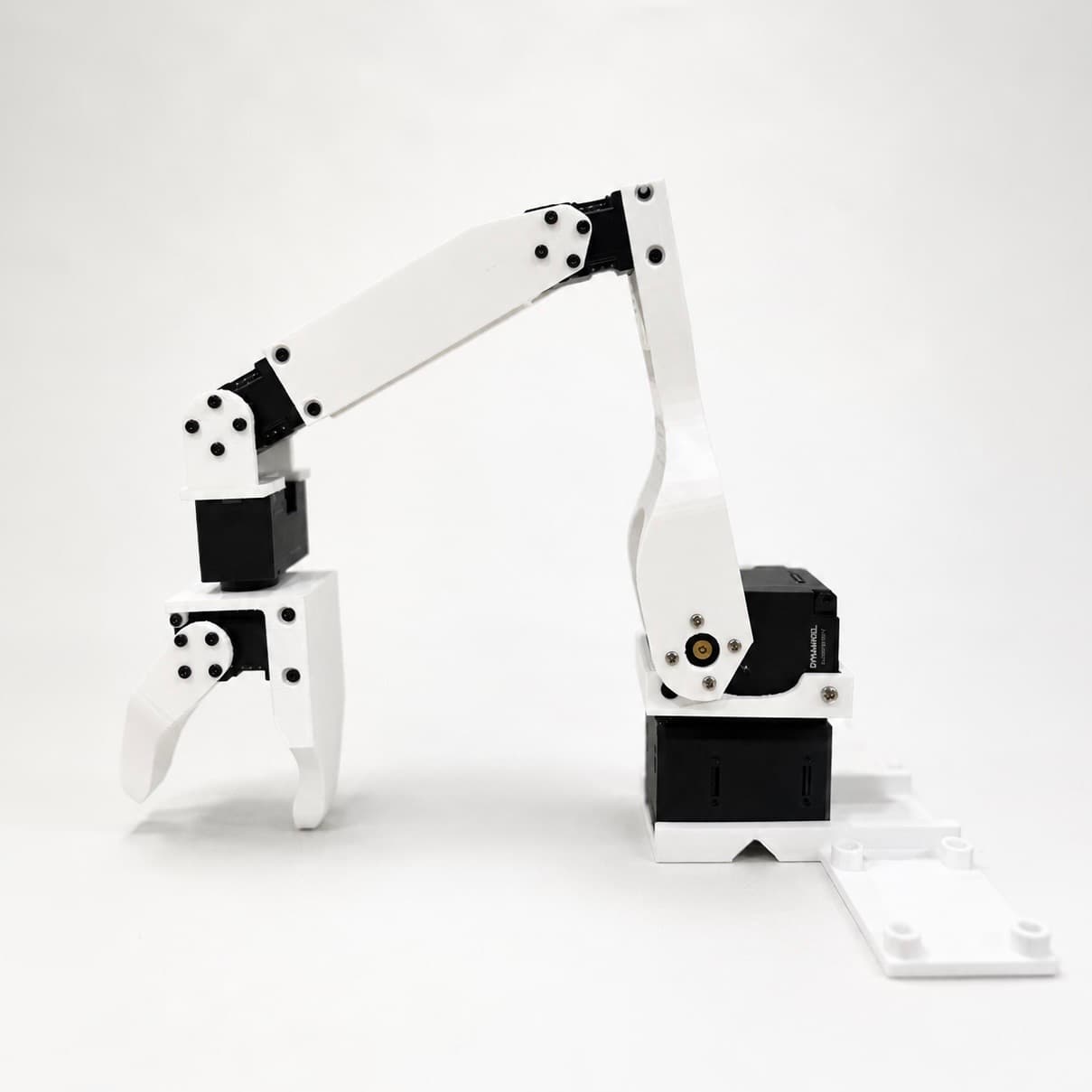A completed white robotic arm with its gripper open.