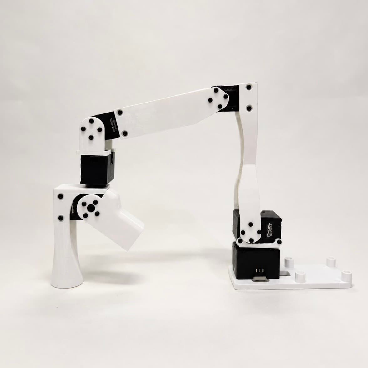 A completed white robotic arm shown from the side.