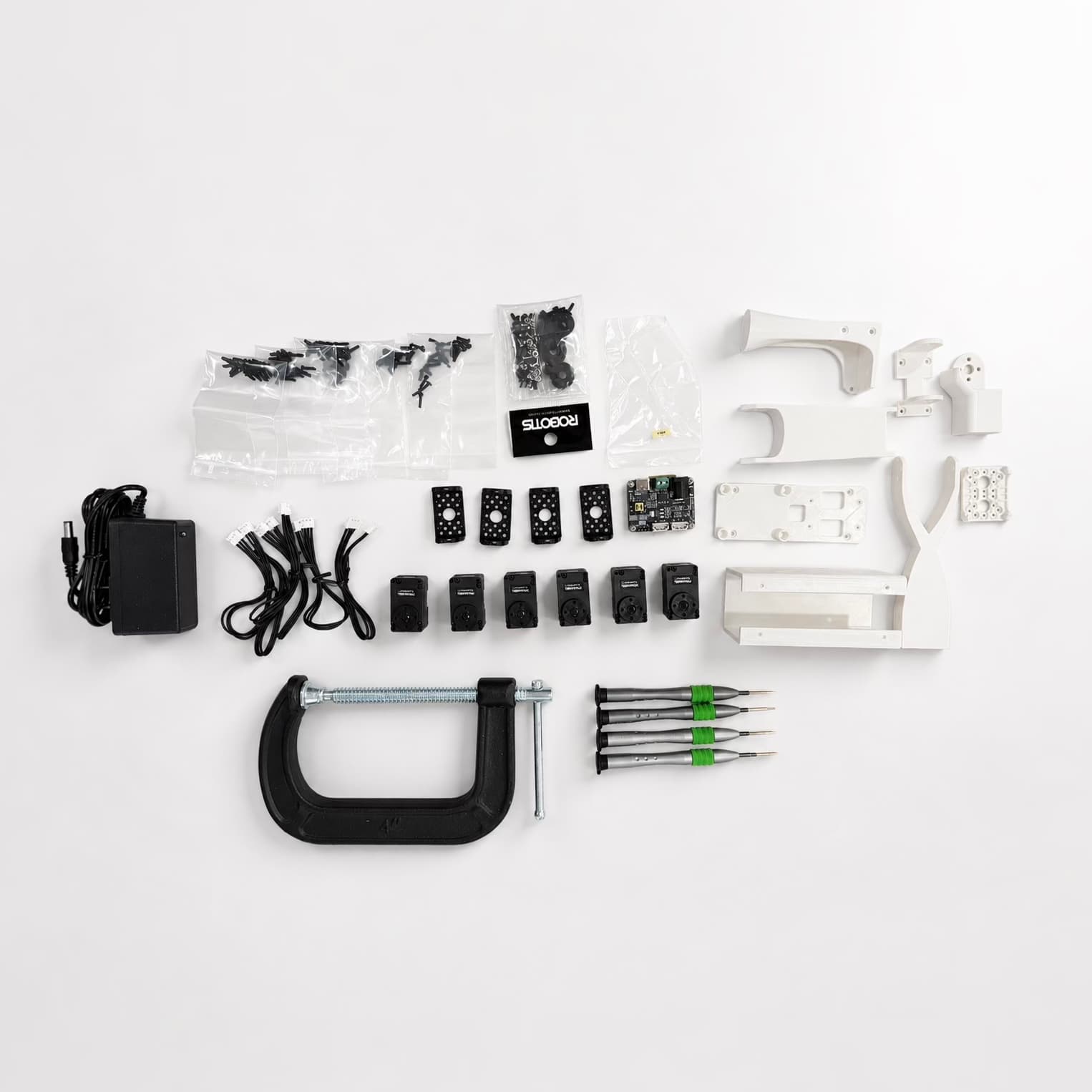 The 3D-printed parts, electronics, fasteners, and tools used to build the robotic arm.